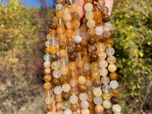 Charger l'image dans la galerie, Perles en quartz hématoïde jaune entre 6 et 10mm