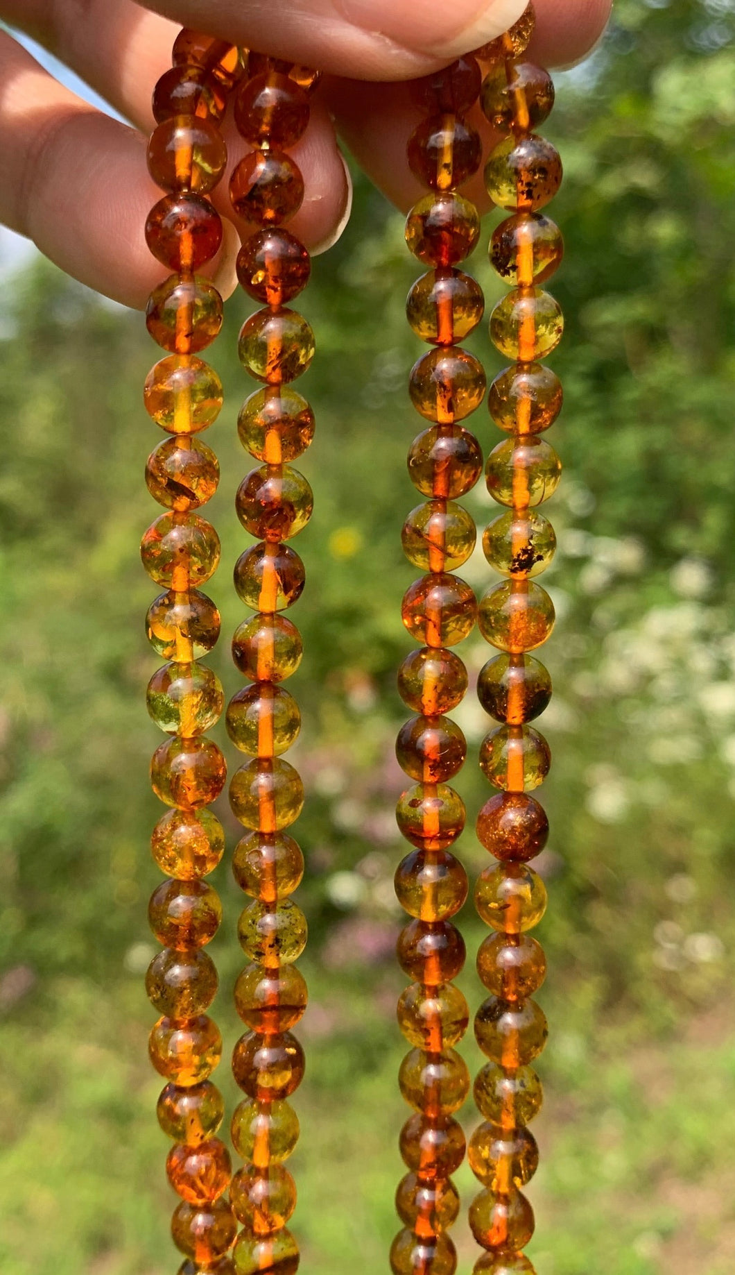 Perles en ambre, couleur orange avec inclusions, 6mm